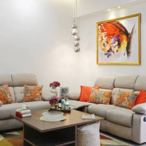 Contemporary 2BHK Flat Design with Bold Cushions and Artistic Wall Frames